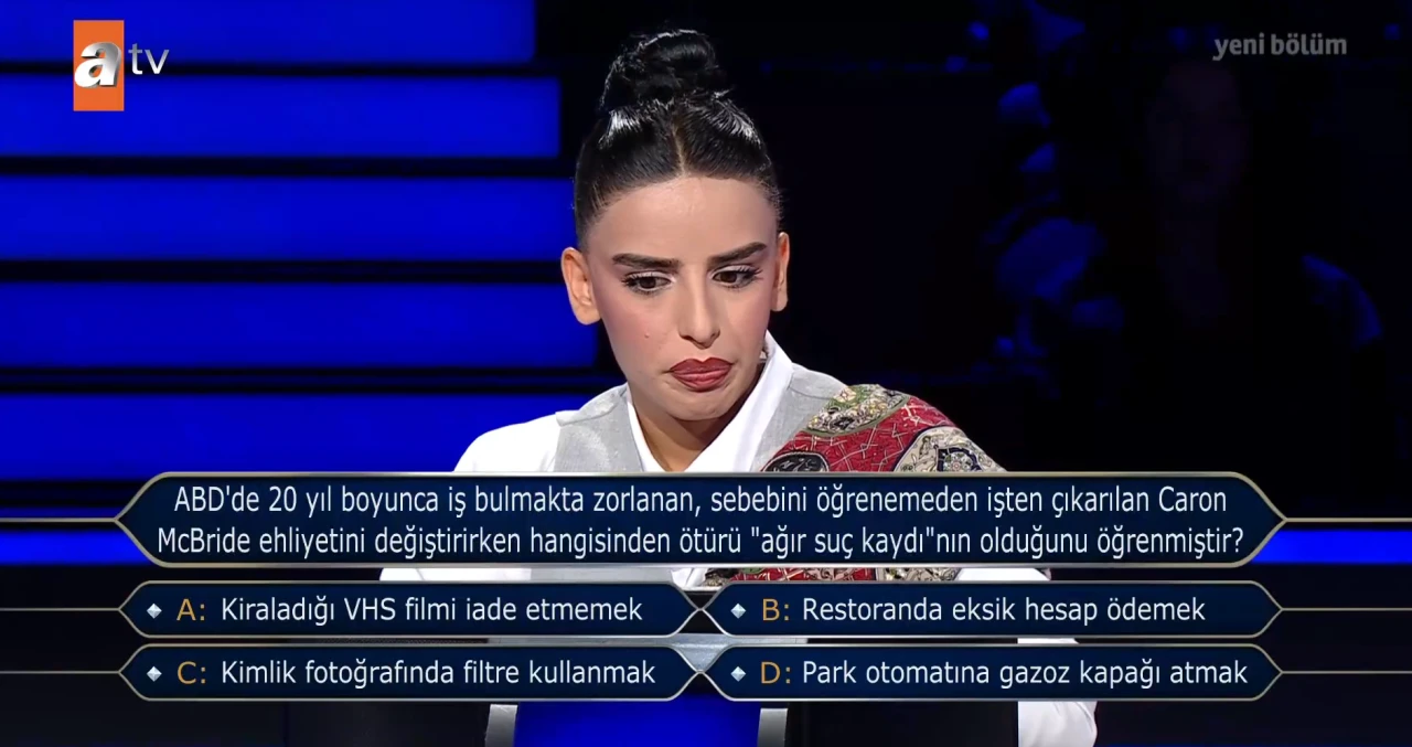 Caron McBride Ehliyetini Değiştirirken Hangisinden Ötürü "Ağır Suç Kaydı"nın Olduğunu Öğrenmiştir? Kim Milyoner Olmak İster